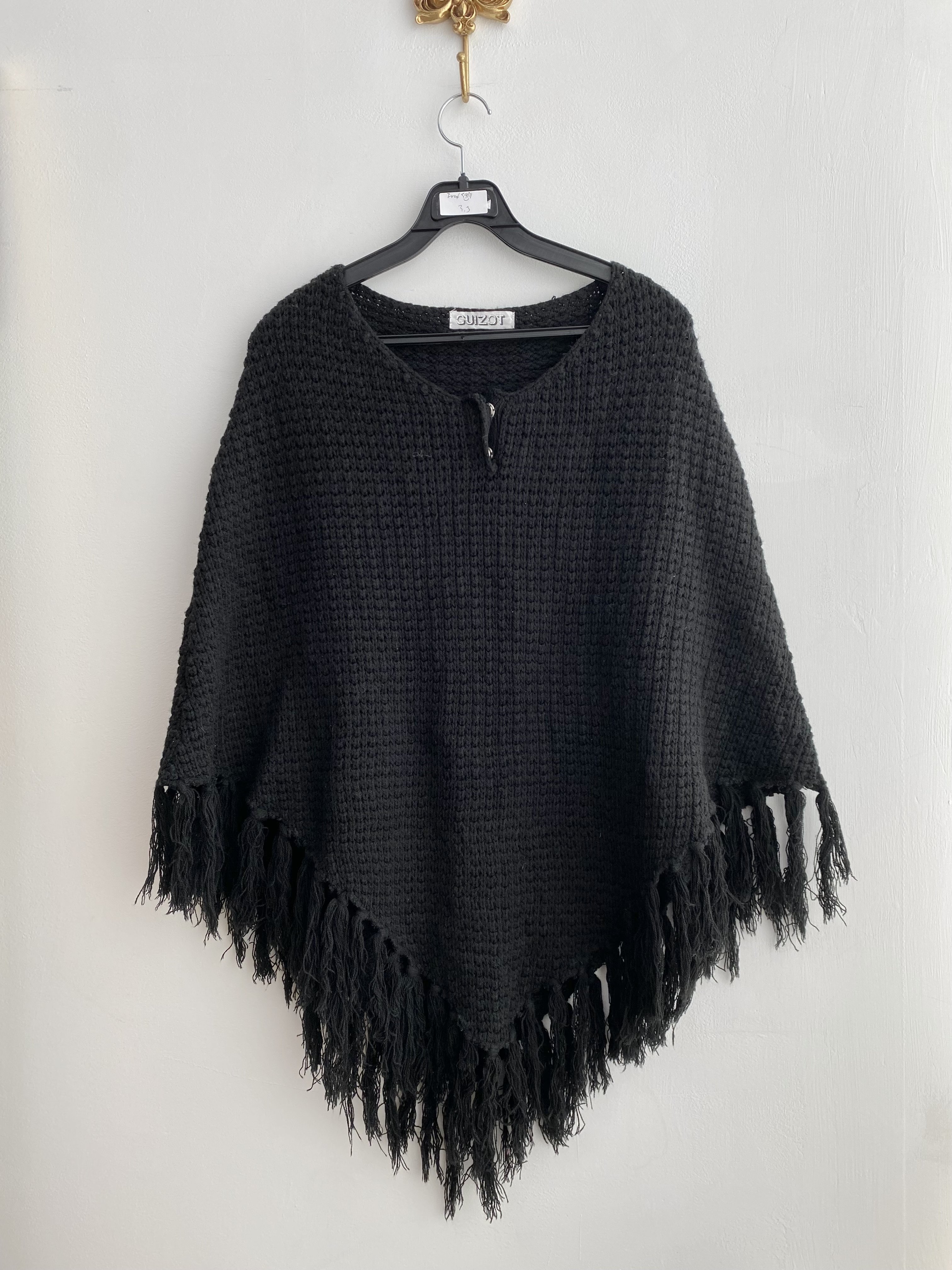 Black poncho style tassel point knit